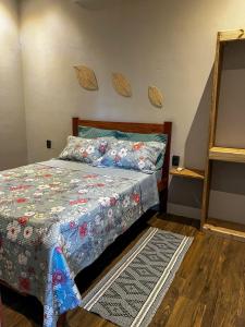 a bedroom with a bed with a quilt on it at Casa verde in Fortim +32 photos