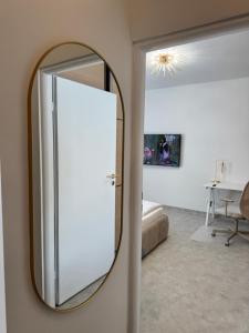 a mirror hanging on a wall in a room at Kopalnia soli apartments in Wieliczka