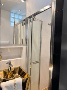 a bathroom with a sink and a shower at Kopalnia soli apartments in Wieliczka +22 photos