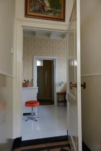 a hallway with a red stool in a room at B&B Chez Nous in Geesteren