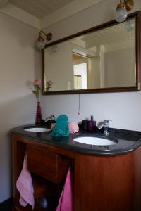 a bathroom with two sinks and a large mirror at B&B Chez Nous in Geesteren +12 photos