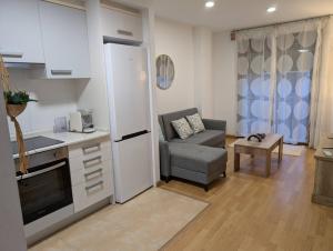 a kitchen with a couch and a chair in a room at IM80 in Montroig