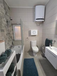 a bathroom with a toilet and a tub and a sink at Aurora in Marsaskala +24 photos
