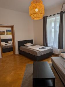 a living room with two beds and a table at Flataid Apartmenthaus Tieschen in Tieschen