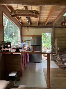 a kitchen with a large island in a room at Chalé Shangri-la in Paraty
