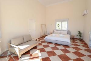 a bedroom with a bed and a couch at Luxury Sea View Villa Oltamar - Single Level - Private Pool - Full Privacy in Calpe