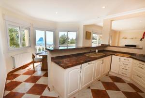 a kitchen with a sink and a counter at Luxury Sea View Villa Oltamar - Single Level - Private Pool - Full Privacy in Calpe