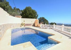 a swimming pool in the backyard of a house at Luxury Sea View Villa Oltamar - Single Level - Private Pool - Full Privacy in Calpe +45 photos