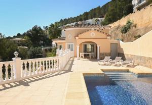 a villa with a swimming pool and a house at Luxury Sea View Villa Oltamar - Single Level - Private Pool - Full Privacy in Calpe