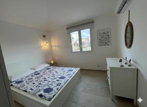 a white bedroom with a bed and a window at Casa vacanza Cipria in Olìa Speciosa