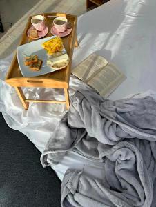 a table with a plate of food and a book on a bed at Hotel Nova El Peñol in El Peñol +42 photos