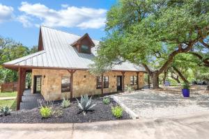 a stone house with a metal roof at Jalsa in Wimberley