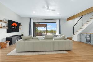 a living room with a couch and a staircase at Jalsa in Wimberley