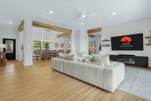 a living room with a white couch and a fireplace at Jalsa in Wimberley +38 photos