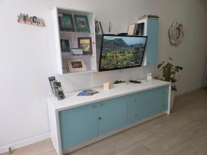 a tv sitting on top of a dresser in a room at Aurora in Marsaskala