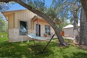 a hammock in front of a house at Comal Cottage in Canyon Lake