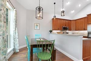 a kitchen with a wooden table and chairs at Comal Cottage in Canyon Lake +14 photos