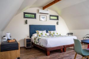 a bedroom with a bed with a blue headboard at Anita y Tomás Bed & Breakfast in Nancagua