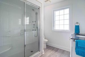 a bathroom with a shower and a toilet and a sink at Apartment in Prince Edward County - 'Suite Spot' in Picton +25 photos