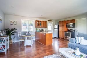 a kitchen and living room with a blue couch at Apartment in Prince Edward County - 'Suite Spot' in Picton