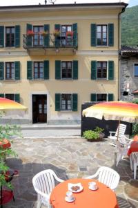 an orange table and chairs in front of a building at Casaria da Adry in Cannobio