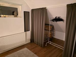 a room with a window with curtains and a floor at Cozy apartment in Kungsbacka