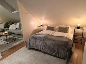a bedroom with a large bed and a couch at Cozy apartment in Kungsbacka