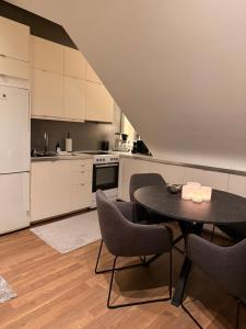 a kitchen with a table and chairs in a room at Cozy apartment in Kungsbacka +3 photos