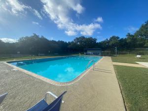 a swimming pool with a blue sky in the background at Coop at Canyon Lake in Canyon Lake
