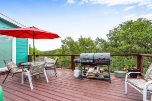 a grill on a deck with a table and chairs at Coop at Canyon Lake in Canyon Lake