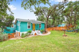 a blue house with a hammock in a yard at Coop at Canyon Lake in Canyon Lake