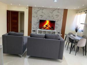 a living room with two couches and a fireplace at Condominio cortico in Mendoza