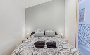 a bedroom with a large bed with two pillows at Les Hirondelles B in Le Crotoy