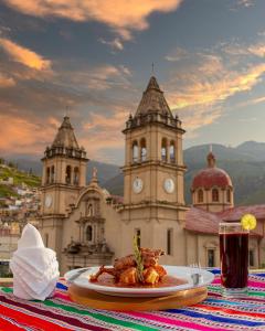 a plate of food on a table in front of a building at Hotel Cipriani in Tarma +55 photos