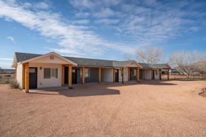 a house in a field with a dirt yard at Red Rock Views Tiny Suite Kanab Basecamp in Kanab