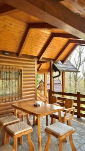 a wooden table and chairs in a cabin at Brvnara Vršac in Vršac