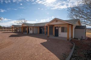 a house with a driveway in front of it at Red Rock Views Tiny Suite Kanab Basecamp in Kanab +26 photos