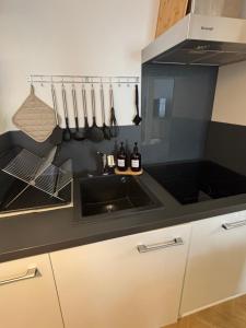 a kitchen with a sink and a microwave at La Parenthèse in Chalons en Champagne +13 photos