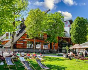 a group of chairs on the grass in front of a building at Hotel Piwniczna SPA&Conference in Piwniczna-Zdrój