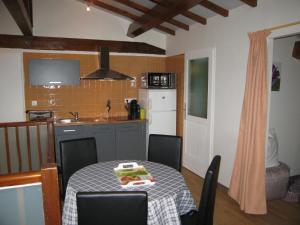 a kitchen with a table with a table cloth on it at "Côté plage" in Aubeterre-sur-Dronne