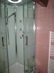 a shower with a glass door in a bathroom at "Côté plage" in Aubeterre-sur-Dronne