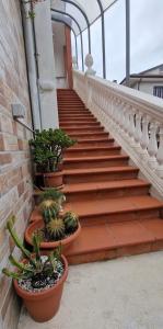 a staircase with potted plants on the side of a building at Due Passi dal Gate in Salerno Airport - Aeroporto di Salerno