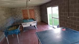 a room with a ping pong table and a pool table at Complejo San Eduardo, Chapadmalal in Colonia Chapadmalal