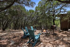 two blue chairs sitting around a camp fire at Lajitas at The Bend in Wimberley