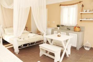 a room with a bed and a table and a table at Santa Irini 1 in Vourvoúlos