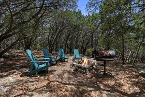 a group of chairs around a fire and a grill at Lajitas at The Bend in Wimberley