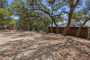 an open yard with trees and a building at Lajitas at The Bend in Wimberley