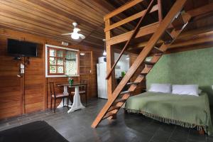 a bedroom with a bed and a wooden ceiling at Morada da Lua - Juquitiba in Juquitiba