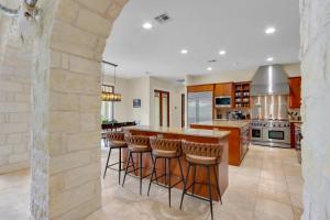 a kitchen with a island with bar stools at Narwhal Ranch in Wimberley