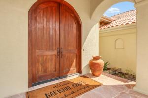 a wooden door of a house with a vase next to it at Narwhal Ranch in Wimberley +64 photos